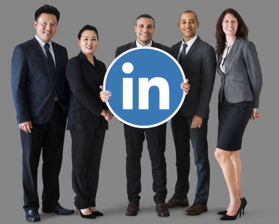 Business people holding a Linkedin logo